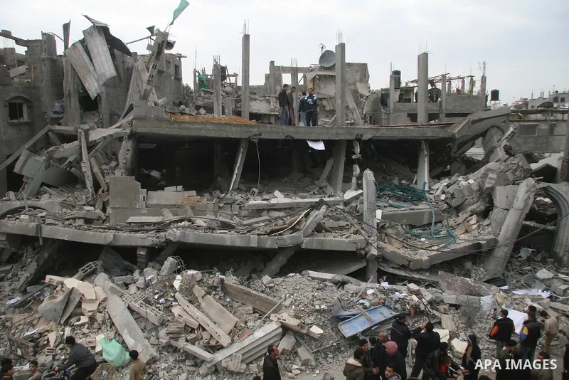 Palestinians look at destroyed buildings after an explosion from an Israeli missile strike in Gaza City. Israeli warplanes pounded the Hamas-ruled Gaza Strip for a third consecutive day on Monday and the Jewish state pre...