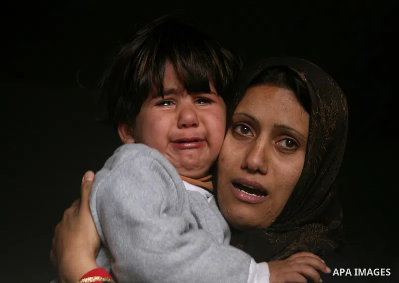 Palestinians mourn during the funeral for 4-year-old Lama Hamdan and her sister Haya in the town of Beit Hanoun in the northern Gaza Strip December 30, 2008. Israel hit the Gaza Strip with more air strikes on Tuesday and...