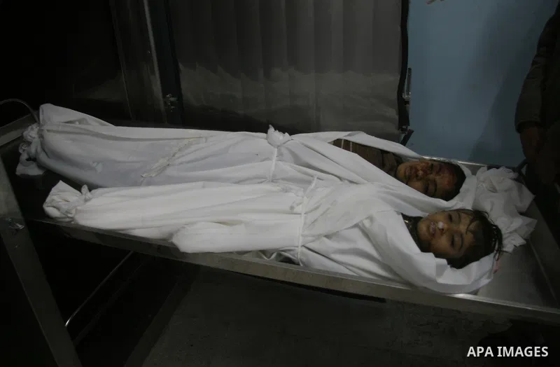 The bodies of two girls, aged four and 11, who were killed in an Israeli air strike in Beit Hanun in the northern Gaza Strip. Israel has rejected global appeals for a truce while massing its forces along the Gaza border...