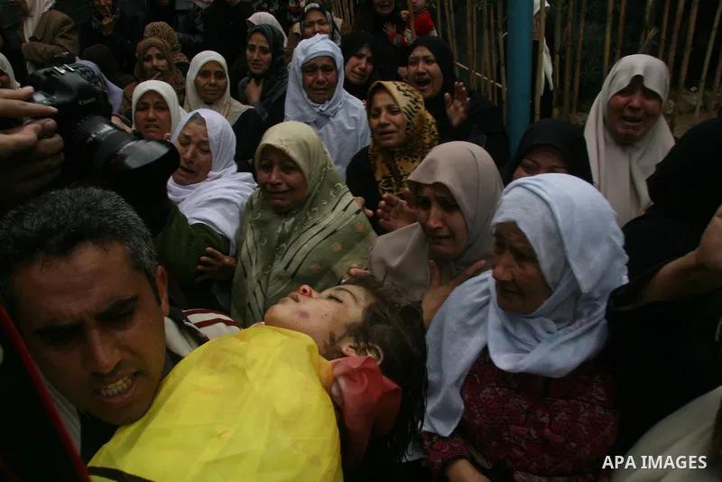 Palestinian relatives of 4-year-old Lama Hamdan mourn near her body during her funeral in the town of Beit Hanoun in the northern Gaza Strip December 30, 2008. Israel on Tuesday rejected any truce with Hamas Islamists in...
