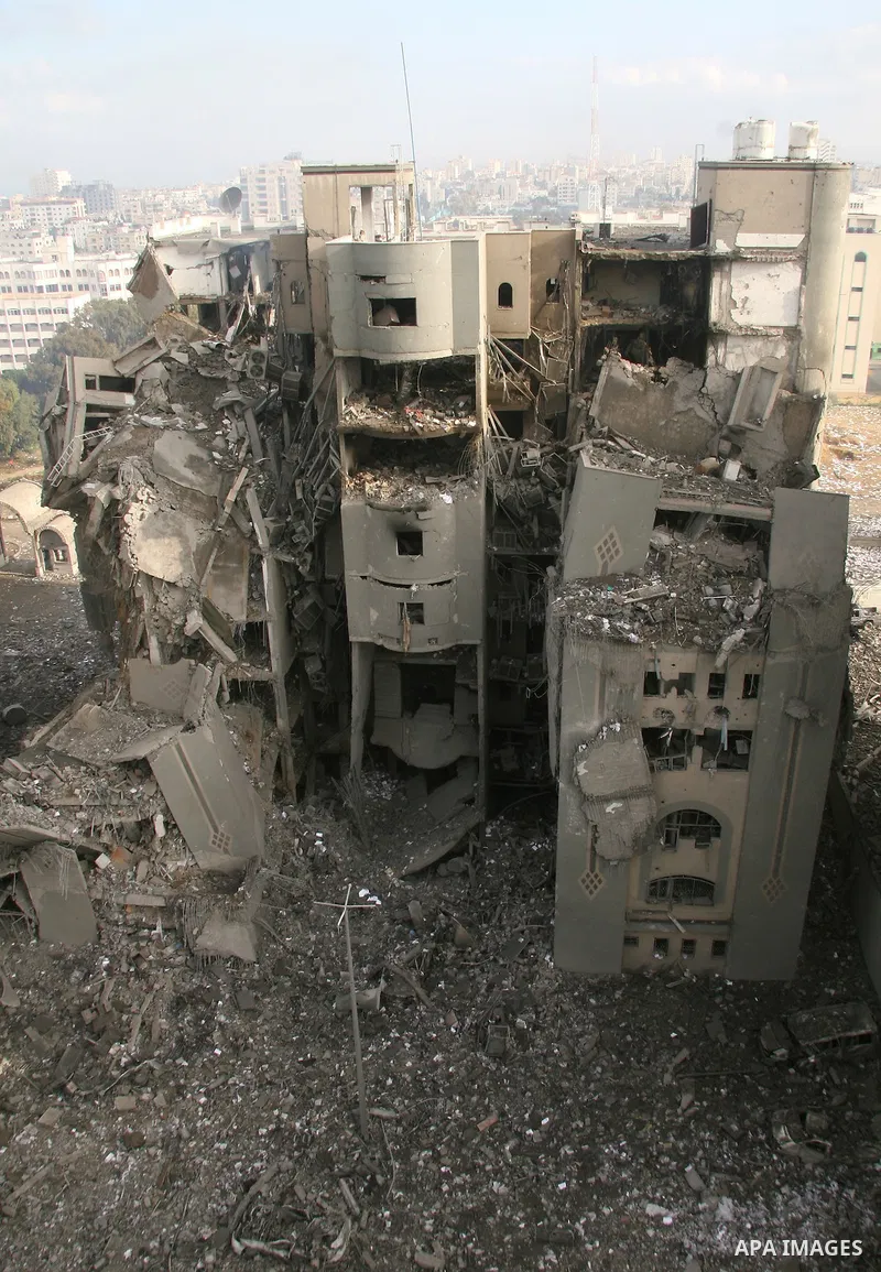A Palestinian man walks past destroyed Hamas government buildings after an Israeli air strike in Gaza December 30, 2008. Israeli warplanes killed 10 Palestinians on Tuesday in attacks that targeted Hamas government build...