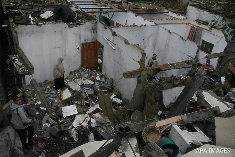Palestinians inspect the b destroyed buildings after an explosion from an Israeli missile strike in Gaza City. Hamas vowed on Wednesday to fight "until the last breath" if Israel makes good on threats to send ground troo...