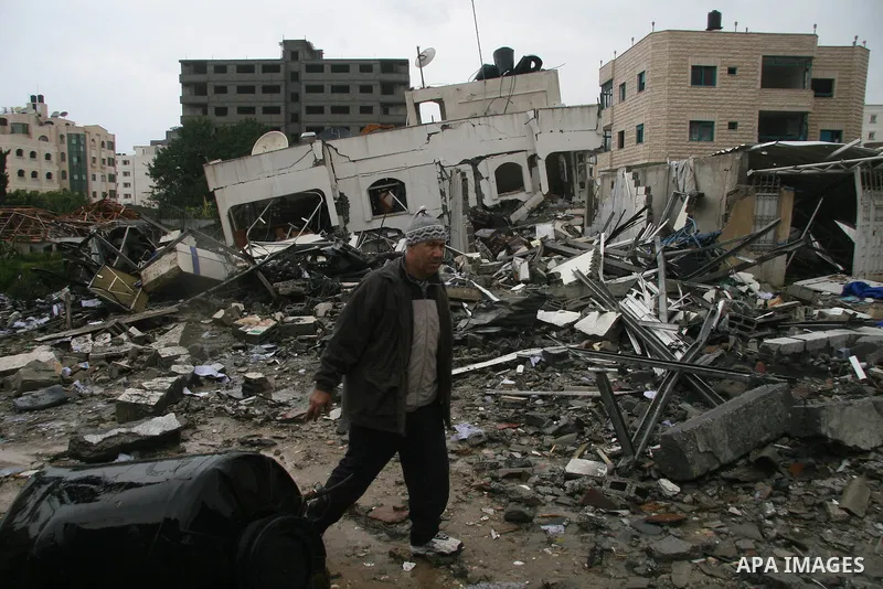 Palestinians inspect the b destroyed buildings after an explosion from an Israeli missile strike in Gaza City. Hamas vowed on Wednesday to fight "until the last breath" if Israel makes good on threats to send ground troo...