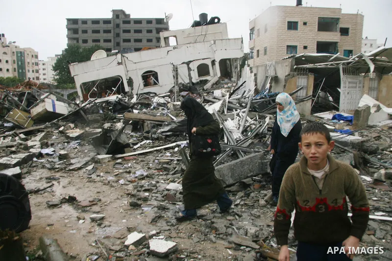 Palestinians inspect the destoryed offices of the head of the Hamas government in Gaza following overnight Israeli airstrikes on Gaza City. Hamas vowed on Wednesday to fight "until the last breath" if Israel makes good o...