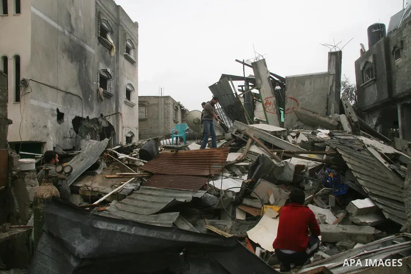 Palestinians inspect the b destroyed buildings after an explosion from an Israeli missile strike in Gaza City. Hamas vowed on Wednesday to fight "until the last breath" if Israel makes good on threats to send ground troo...