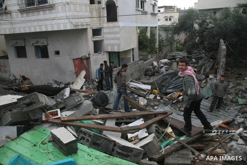 Palestinians inspect the b destroyed buildings after an explosion from an Israeli missile strike in Gaza City. Hamas vowed on Wednesday to fight "until the last breath" if Israel makes good on threats to send ground troo...