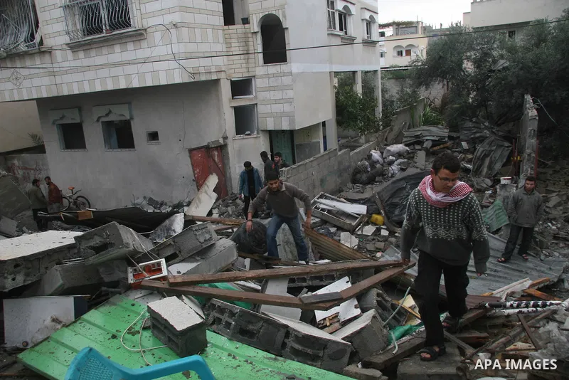 Palestinians inspect the b destroyed buildings after an explosion from an Israeli missile strike in Gaza City. Hamas vowed on Wednesday to fight "until the last breath" if Israel makes good on threats to send ground troo...