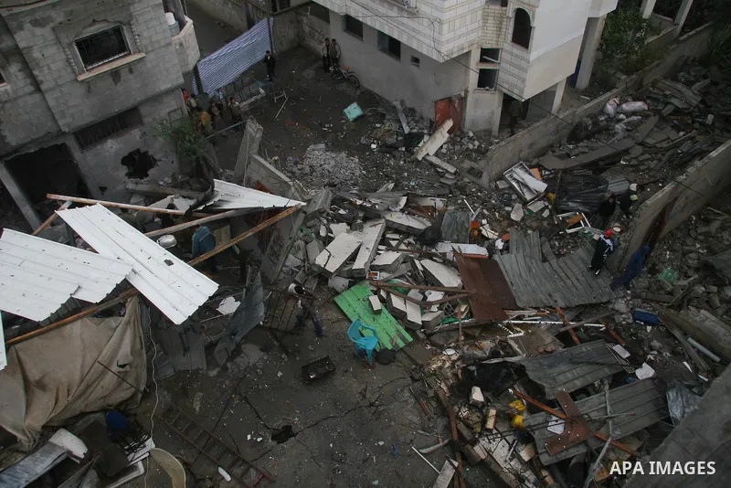Palestinians inspect the b destroyed buildings after an explosion from an Israeli missile strike in Gaza City. Hamas vowed on Wednesday to fight "until the last breath" if Israel makes good on threats to send ground troo...