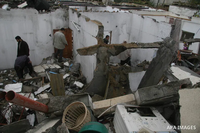 Palestinians inspect the b destroyed buildings after an explosion from an Israeli missile strike in Gaza City. Hamas vowed on Wednesday to fight "until the last breath" if Israel makes good on threats to send ground troo...