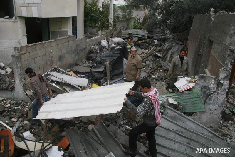 Palestinians inspect the b destroyed buildings after an explosion from an Israeli missile strike in Gaza City. Hamas vowed on Wednesday to fight "until the last breath" if Israel makes good on threats to send ground troo...