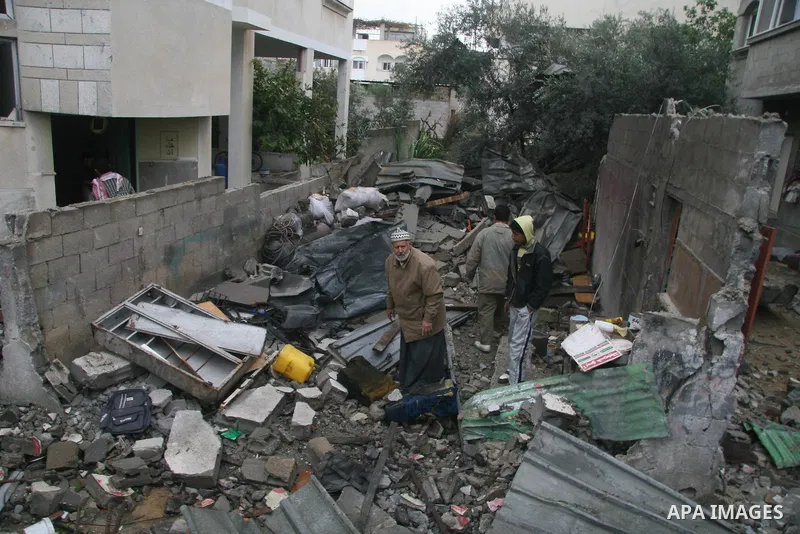 Palestinians inspect the b destroyed buildings after an explosion from an Israeli missile strike in Gaza City. Hamas vowed on Wednesday to fight "until the last breath" if Israel makes good on threats to send ground troo...