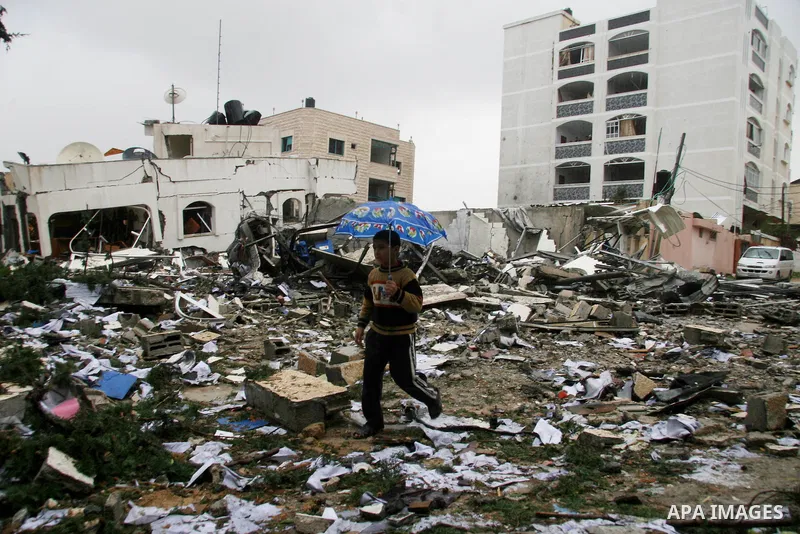 Palestinians inspect the destoryed offices of the head of the Hamas government in Gaza following overnight Israeli airstrikes on Gaza City. Hamas vowed on Wednesday to fight "until the last breath" if Israel makes good o...
