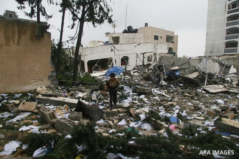 Palestinians inspect the destoryed offices of the head of the Hamas government in Gaza following overnight Israeli airstrikes on Gaza City. Hamas vowed on Wednesday to fight "until the last breath" if Israel makes good o...
