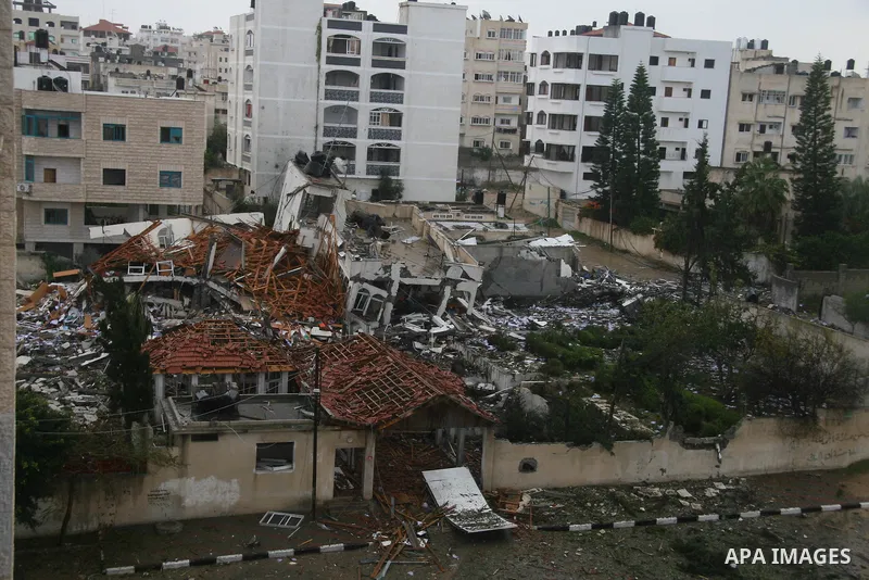 Palestinians inspect the destoryed offices of the head of the Hamas government in Gaza following overnight Israeli airstrikes on Gaza City. Hamas vowed on Wednesday to fight "until the last breath" if Israel makes good o...