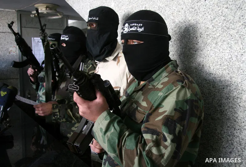 Masked spokesmen for Hamas-allied violent group the Popular Resistance Committees hold a press conference to announce their victory in the conflict with Israel, in Gaza City, Thursday, Jan. 22, 2009. Israel waged a 22-da...