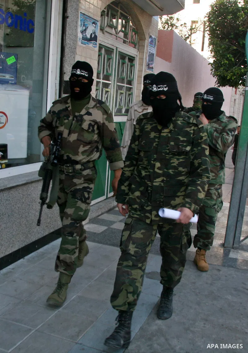 Masked spokesmen for Hamas-allied violent group the Popular Resistance Committees hold a press conference to announce their victory in the conflict with Israel, in Gaza City, Thursday, Jan. 22, 2009. Israel waged a 22-da...