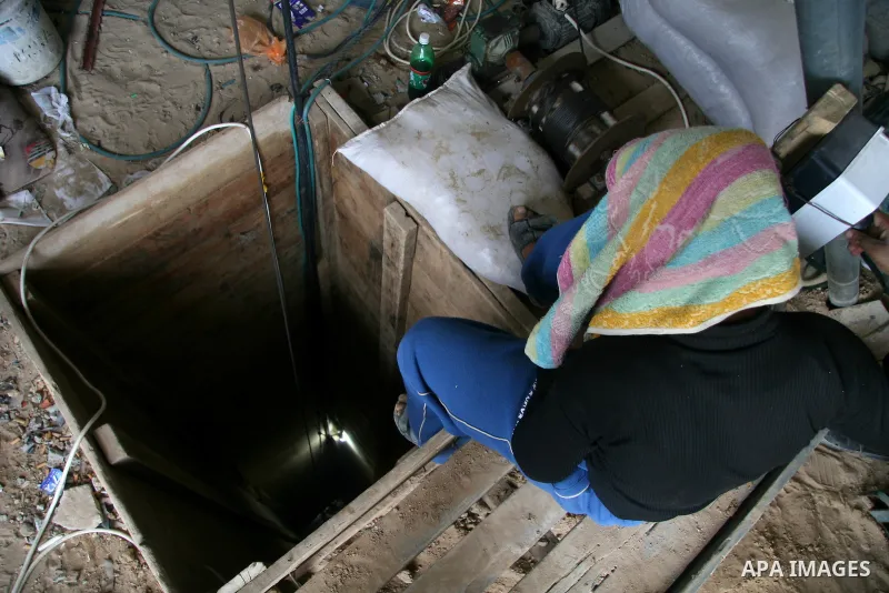 A Palestinian smuggler works in a tunnel in Rafah, southern Gaza Strip, on the border with Egypt, Monday, Jan. 26, 2009. Gaza smugglers are actively working on their tunnels, bringing in food, fuel and other goods just d...