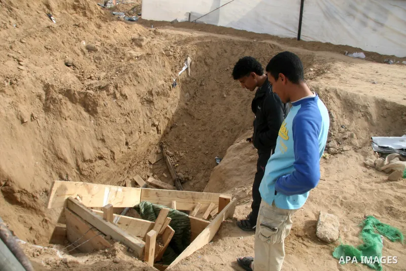 A Palestinian smuggler works in a tunnel in Rafah, southern Gaza Strip, on the border with Egypt, Monday, Jan. 26, 2009. Gaza smugglers are actively working on their tunnels, bringing in food, fuel and other goods just d...