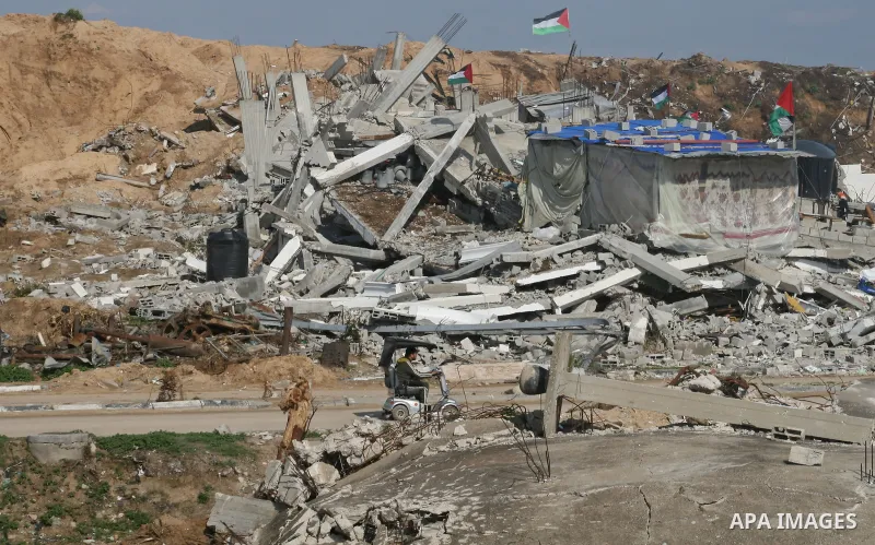 A Palestinian family sit on the rubble of their home destroyed during Israel's 22-day offensive in Jabalia in the northern Gaza Strip on February 18, 2009 APAIMAGES PHOTO / Ashraf Amra
