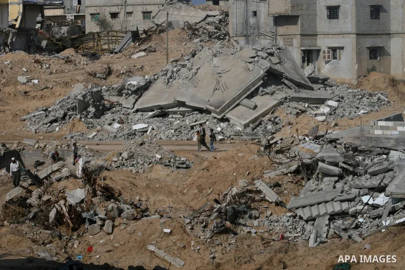 A Palestinian family sit on the rubble of their home destroyed during Israel's 22-day offensive in Jabalia in the northern Gaza Strip on February 18, 2009 APAIMAGES PHOTO / Ashraf Amra
