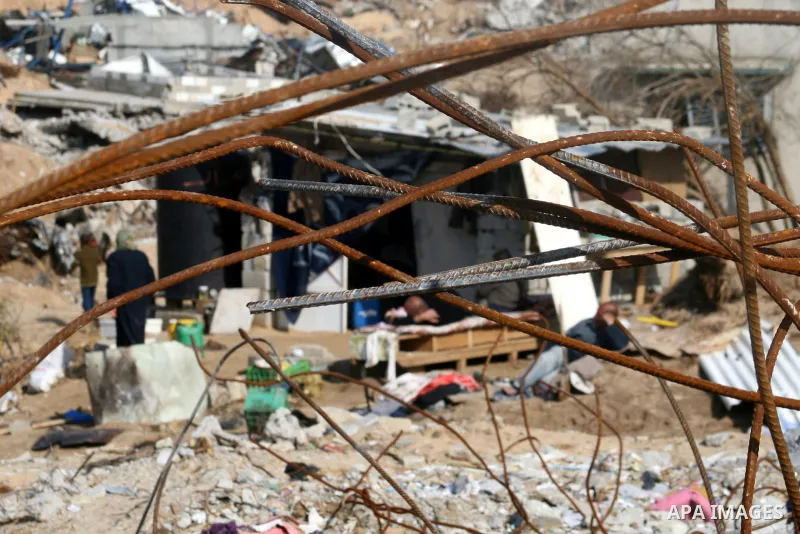A Palestinian family sit on the rubble of their home destroyed during Israel's 22-day offensive in Jabalia in the northern Gaza Strip on February 18, 2009 APAIMAGES PHOTO / Ashraf Amra