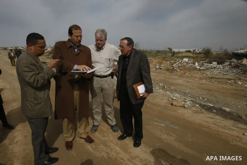 US Democratic Congressmen Keith Ellison (L) and Brian Baird (2nd L) and senior policy advisor Nicholas Palarino (2nd R) speak with a Palestinian owner of a company that was destroyed during Israel's 22-day offensive duri...