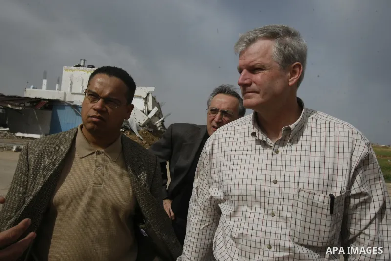 US Democratic Congressmen Keith Ellison (L) and Brian Baird (2nd L) and senior policy advisor Nicholas Palarino (2nd R) speak with a Palestinian owner of a company that was destroyed during Israel's 22-day offensive duri...