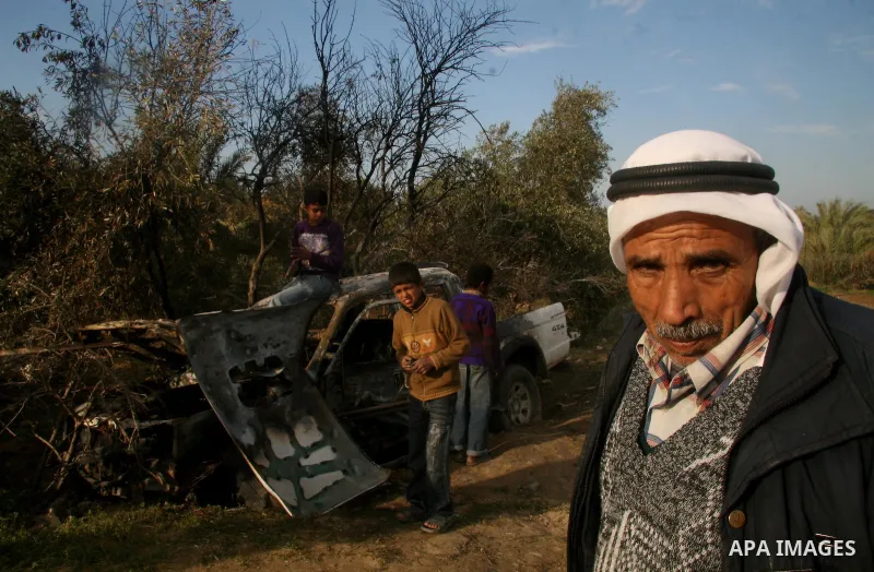Palestinians inspect a destroyed car following an Israeli air strike in the central Gaza Strip refugee camp of Maghazi on February 23, 2009. The Israeli army carried out an air raid in the central Gaza Strip after a mili...