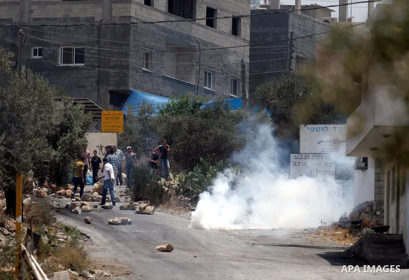 Israeli soldiers fire teargas and rubber bullets at Palestinian protestors during a demonstration against the construction of the controversial Israeli cement barrier in the West Bank village of Nilin near Ramallah.