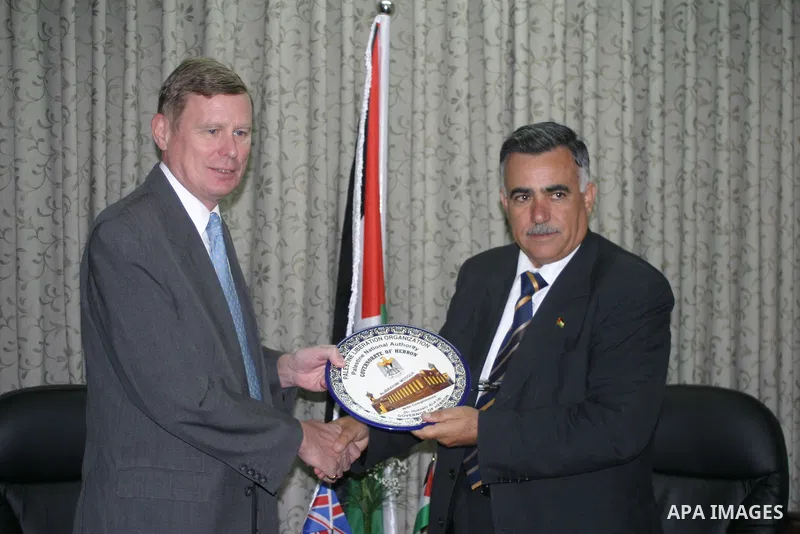 Palestinian Governor of Hebron Hussein al-Araj (R) receives the British Consul in Jerusalem Retchard Makepeas, during his visit to the West Bank city of Hebron.