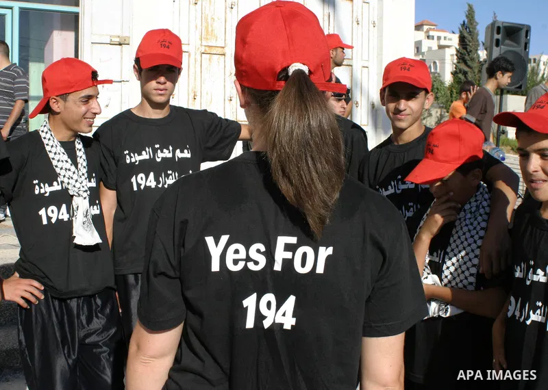 Palestinians perform a traditional dance as they protest and demanding the right of return for those who fled their homes during the 1948 war that followed the creation of Israel, in the west bank town of Halhoul, northe...