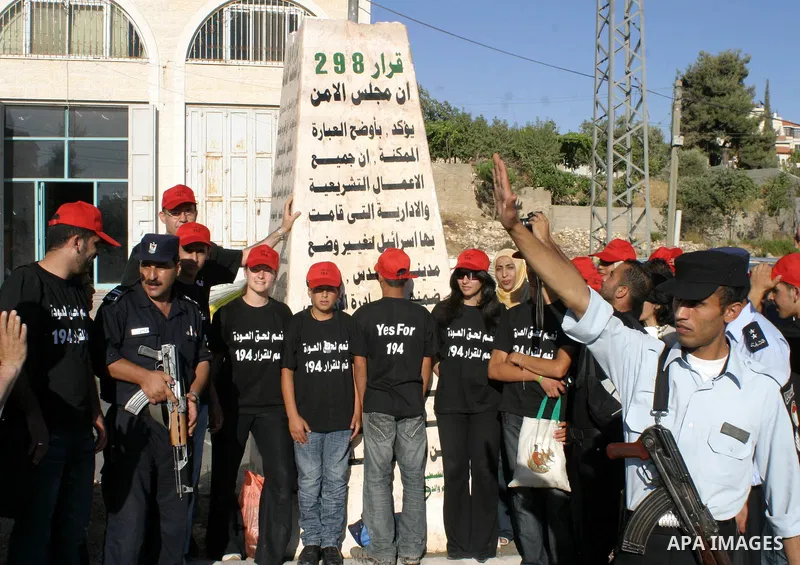 Palestinians perform a traditional dance as they protest and demanding the right of return for those who fled their homes during the 1948 war that followed the creation of Israel, in the west bank town of Halhoul, northe...