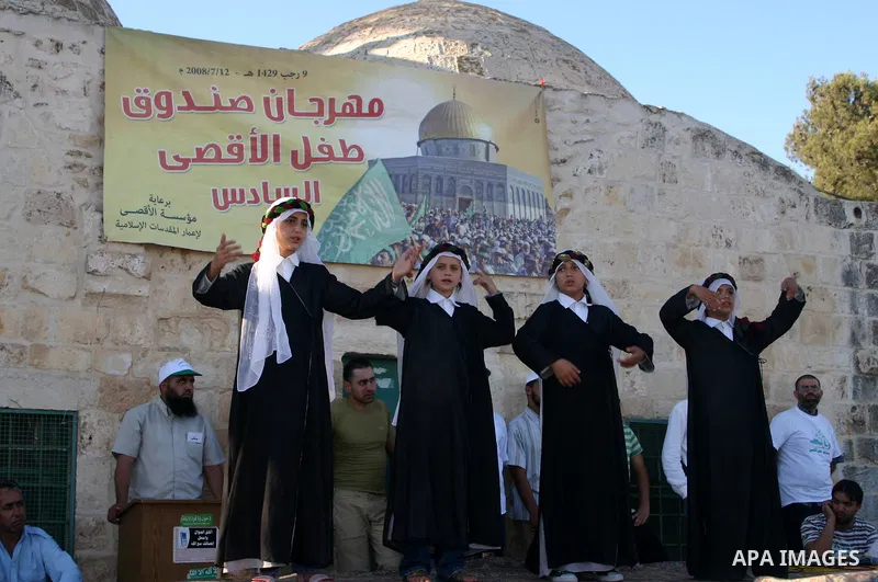 Palestinians attend the sixth festival of "Aqsa Child Box" for collect the donations under the custody of Aqsa institution for protect the Islamic Noble sanctuaries, inside the Aqsa Mosque Yard in Jerusalem city.
