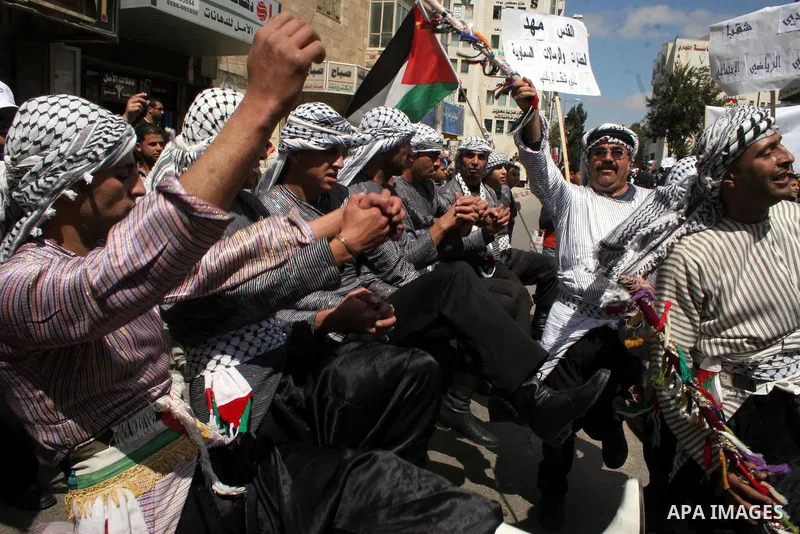 Palestinians take part in a traditional parade in the streets of the West Bank city of Ramallah on March 21, 2009 to celebrate Jerusalem's designation as the 2009 'capital of Arab culture'. Celebrations in the West Bank...