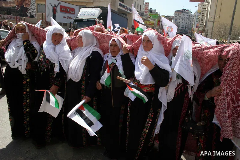 Palestinians take part in a traditional parade in the streets of the West Bank city of Ramallah on March 21, 2009 to celebrate Jerusalem's designation as the 2009 'capital of Arab culture'. Celebrations in the West Bank...