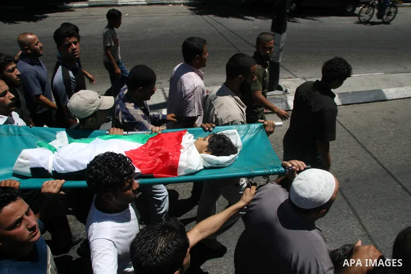 Palestinians mourners carry the body of five year-old girl, Siren al-Safdi, wrapped in a Palestinian flag, during a funeral in Gaza City after she as killed yesterday in a bomb blast. Hamas-run security forces fanned out...