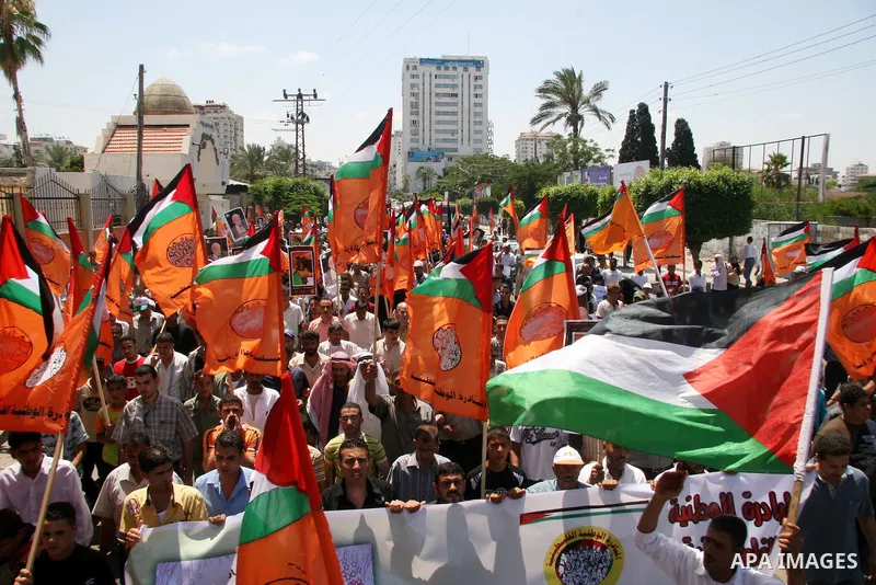 Palestinians hold their country's flag and placards as they attend a rally calling for the national conciliation and end the difference between Hamas and Fatah parties, in Gaza City.