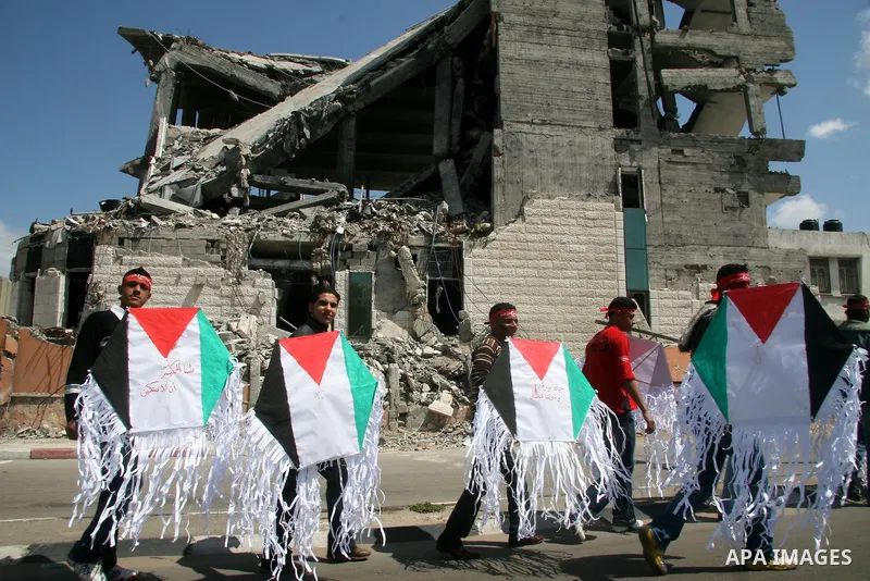 Supporters of the Popular Front for the Liberation of Palestine (PFLP) hold kites with colours of their national flag during a demonstration to mark Land Day in Gaza City on March 30, 2009. Land Day commemorates the kill...