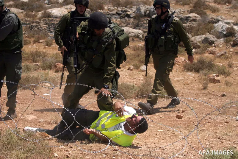 Palestinians scuffle with Israeli border police officers during a demonstration against Israel's controversial separation barrier in the West Bank village of Nilin, near Ramallah. Five Palestinians were wounded today as...