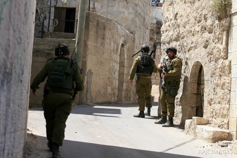 Israeli soldiers are seen during clashes with Palestinian youths near the construction site of Israel's controversial separation barrier in the West Bank village of Nilin, west of Ramallah. Israel says the barrier, which...