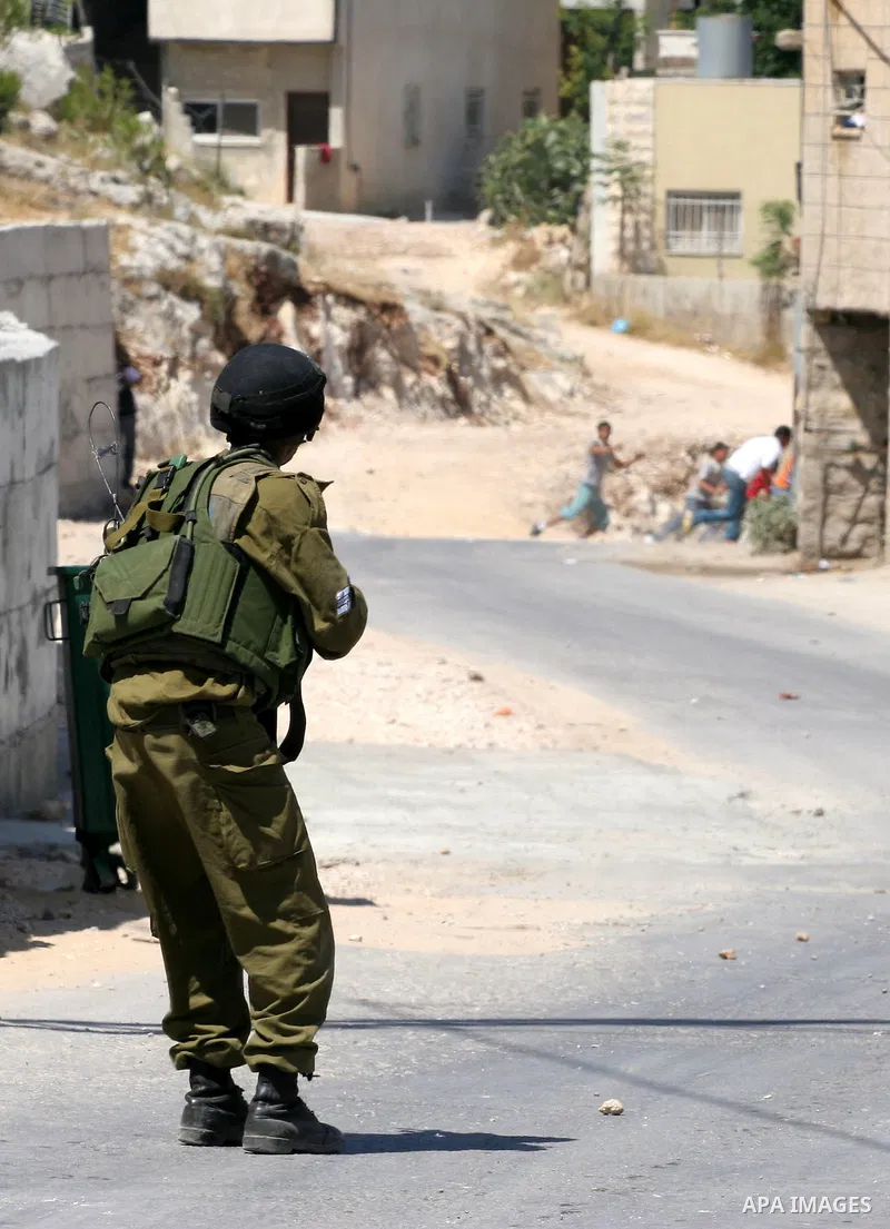 Israeli soldiers are seen during clashes with Palestinian youths near the construction site of Israel's controversial separation barrier in the West Bank village of Nilin, west of Ramallah. Israel says the barrier, which...
