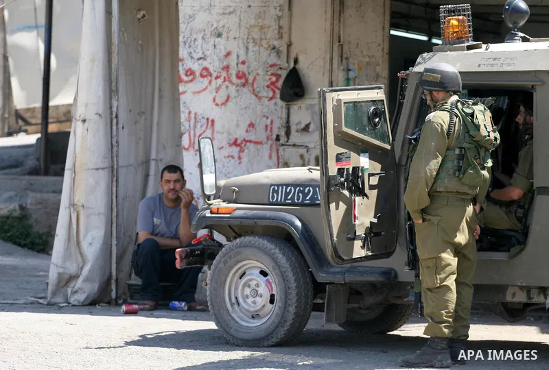 Israeli soldiers are seen during clashes with Palestinian youths near the construction site of Israel's controversial separation barrier in the West Bank village of Nilin, west of Ramallah. Israel says the barrier, which...