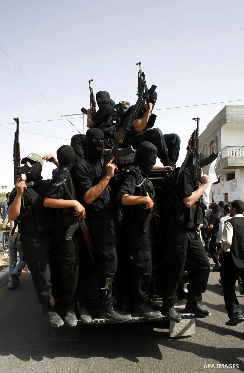 Militants from the Hamas movement attend the funeral of fellow fighter Ahmed Suleiman in Rafah town in the southern Gaza Strip. Suleiman was one of four Hamas fighters who detonated two booby-trapped vehicles disguised a...