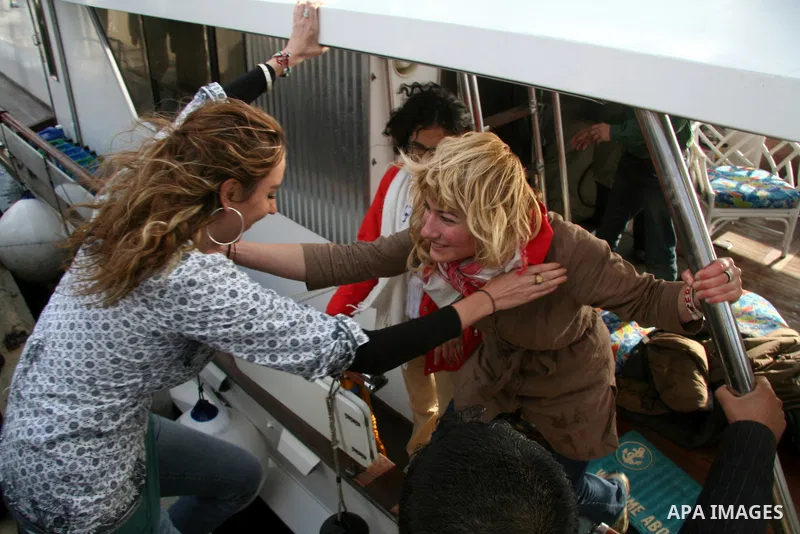 Palestinians receive a boat carrying a group of pro-Palestinian peace activists and European politicians upon its arrival in Gaza City. Israel allowed the "Dignity," a small yacht, to sail to the Gaza Strip in the fourth...