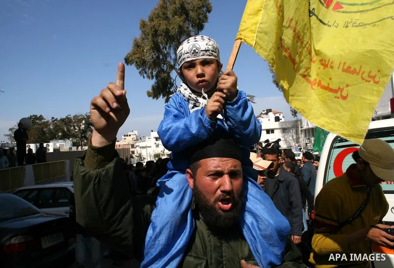 A man holds his son during the funeral of 6-month-old Palestinian baby Mohammed al-Borai in Gaza February 28, 2008. Al-Borai was killed after Israeli military aircraft bombed the Hamas-run Interior Ministry in Gaza city...