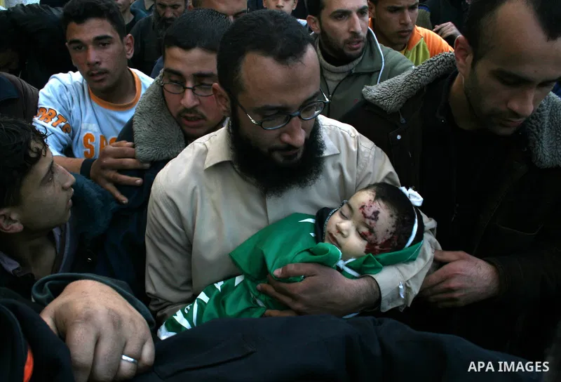 The father of six-month-old Mohammed Bourai carries his dead son to his funeral in Gaza City on February 28, 2008, following his death in an Israeli airstrike on a building housing the Hamas-run government's interior min...