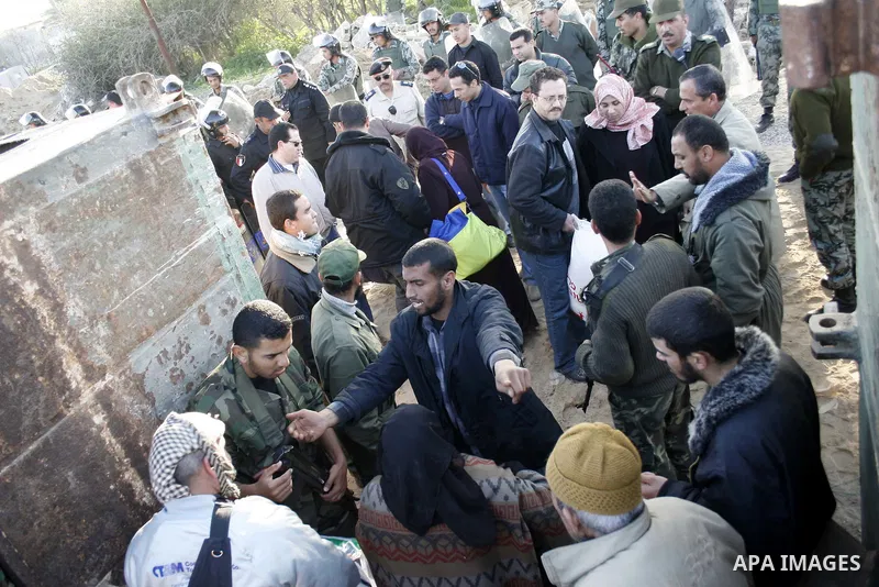 Palestinians who was stuck at Egypt as they wait to cross into Gaza at Rafah's border crossing, southern Gaza Strip. Egypt has warned Palestinians against trying to break through its resealed Gaza border about two weeks...