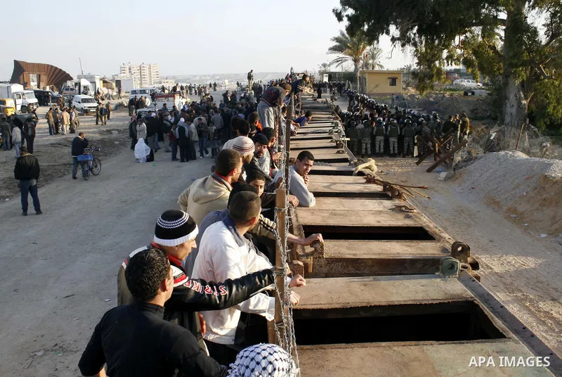Palestinians who was stuck at Egypt as they wait to cross into Gaza at Rafah's border crossing, southern Gaza Strip. Egypt has warned Palestinians against trying to break through its resealed Gaza border about two weeks...