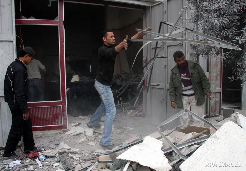 A Palestinian man inspects the damages inside his shop following an overnight Israeli strike which targeted the nearby labour syndicate headquarters in Gaza City. Israeli Deputy Defence Minister Matan Vilnai warned today...