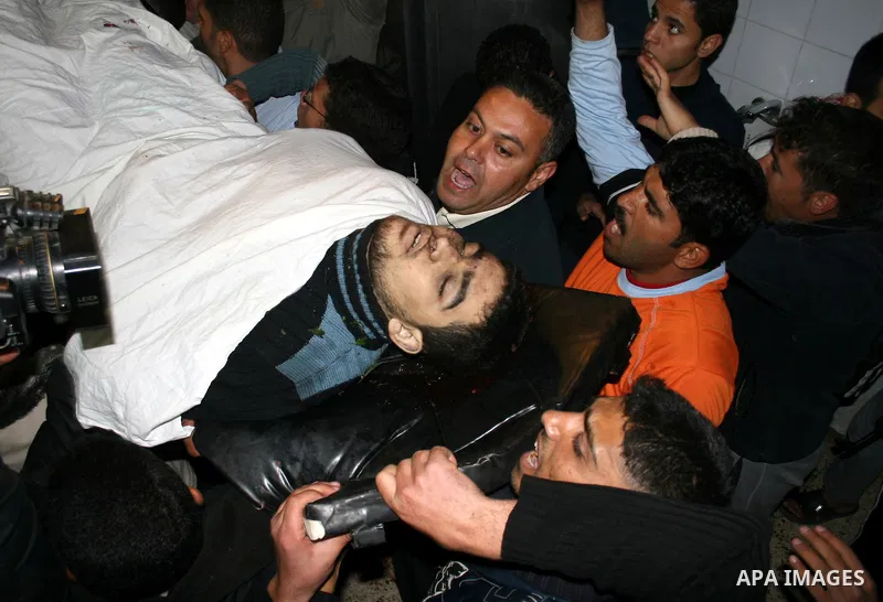 Palestinians carry the body of one of three Islamic Jihad militants killed in Israeli airstrikes to the morgue of al-Shifa hospital in Gaza City. Israeli aircraft killed three members of Islamic Jihad who were preparing...